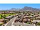 Expansive aerial view of a desert community with well-maintained homes and stunning mountain backdrop on a sunny day at 2605 Orchid Valley Dr, Las Vegas, NV 89134