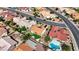 Aerial view showcasing a home's putting green, pool, covered patio, and pristine desert landscaping at 2605 Orchid Valley Dr, Las Vegas, NV 89134