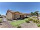 Beautiful backyard with well-manicured desert landscaping, artificial turf, and a putting green at 2605 Orchid Valley Dr, Las Vegas, NV 89134
