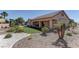Well landscaped backyard featuring desert landscaping, a small putting green, and a covered patio at 2605 Orchid Valley Dr, Las Vegas, NV 89134