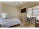 Simple bedroom with a TV, a desk, and a large window with blinds at 2605 Orchid Valley Dr, Las Vegas, NV 89134