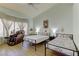 Cozy bedroom with two twin beds, a ceiling fan, and a comfortable massage chair at 2605 Orchid Valley Dr, Las Vegas, NV 89134