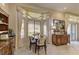 Inviting dining area with a four-seater table set next to a large bright window at 2605 Orchid Valley Dr, Las Vegas, NV 89134