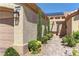Inviting front entrance with decorative trees and shrubs along a brick paver walkway to the front door at 2605 Orchid Valley Dr, Las Vegas, NV 89134