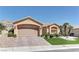 Lovely single-story home with a two-car garage, desert landscaping, and lush green lawn in front yard at 2605 Orchid Valley Dr, Las Vegas, NV 89134