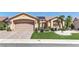 Beautiful single-story home featuring a manicured front yard and two-car garage with brick paver driveway at 2605 Orchid Valley Dr, Las Vegas, NV 89134