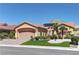 Charming one-story home with desert landscaping, artificial lawn, and a two-car garage with brick paver driveway at 2605 Orchid Valley Dr, Las Vegas, NV 89134