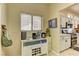 Kitchen adjacent bar featuring a wine rack, coffee machine, and view of the kitchen at 2605 Orchid Valley Dr, Las Vegas, NV 89134