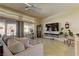 Bright living room with neutral tones, tile flooring, and expansive windows offering natural light and outdoor views at 2605 Orchid Valley Dr, Las Vegas, NV 89134