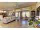 Bright living room featuring neutral color palette, tile floors, and large windows overlooking the backyard at 2605 Orchid Valley Dr, Las Vegas, NV 89134