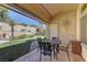 Outdoor patio area with seating and a view of the landscaped yard and brick fence at 2605 Orchid Valley Dr, Las Vegas, NV 89134