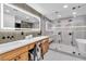 Luxurious bathroom featuring double vanities, a glass shower, and a soaking tub at 3189 Montecito Dr, Las Vegas, NV 89120