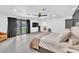 Open main bedroom with a king-size bed, dark accent wall, and sliding glass doors overlooking the backyard at 3189 Montecito Dr, Las Vegas, NV 89120