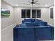 Large living room with blue sectional sofa and scenic night views through the window at 342 Molinetto St, Las Vegas, NV 89138