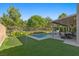 This backyard boasts a pool, putting green, covered patio, and lush landscaping at 364 Trentino Alto St, Henderson, NV 89012