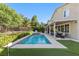 The backyard has a pool, covered patio, putting green, and fence at 364 Trentino Alto St, Henderson, NV 89012