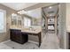 Well-lit primary bathroom with dual sinks, a vanity area, and access to a hallway with closet at 364 Trentino Alto St, Henderson, NV 89012