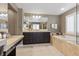 Bathroom featuring a large bathtub, double sinks, and a large mirror at 364 Trentino Alto St, Henderson, NV 89012