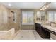 Bathroom featuring double sinks, large mirrors, a shower, and a window at 364 Trentino Alto St, Henderson, NV 89012