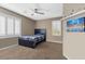 Bright bedroom with a ceiling fan, a bed with a blue blanket, and a window with shutters at 364 Trentino Alto St, Henderson, NV 89012