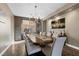 Dining room featuring a decorative chandelier, a large window, and wood floors at 364 Trentino Alto St, Henderson, NV 89012