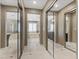 Hallway with closet leading to primary bathroom featuring a tub and shower at 364 Trentino Alto St, Henderson, NV 89012