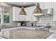 Bright kitchen with white cabinets, granite counters, stainless appliances and tile backsplash at 364 Trentino Alto St, Henderson, NV 89012
