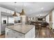 Open concept kitchen; white cabinets, stainless appliances, and large island with seating at 364 Trentino Alto St, Henderson, NV 89012
