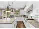 Bright kitchen with white cabinets, granite countertops, stainless appliances and diamond tile backsplash at 364 Trentino Alto St, Henderson, NV 89012