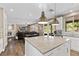 Open concept kitchen and living room space; white cabinets, granite counters, stainless appliances at 364 Trentino Alto St, Henderson, NV 89012