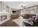 Bright living room with fireplace, ceiling fan, and large windows at 364 Trentino Alto St, Henderson, NV 89012