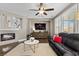 Living room featuring a fireplace, a large television, and plenty of natural light at 364 Trentino Alto St, Henderson, NV 89012