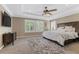 Well-lit main bedroom with a ceiling fan, a large window, and a dresser at 364 Trentino Alto St, Henderson, NV 89012