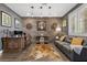 Comfortable home office with exposed brick accent wall, hardwood flooring, and modern decor at 364 Trentino Alto St, Henderson, NV 89012