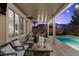 Inviting covered patio with a cozy fire pit, comfortable seating, and atmospheric string lights for evening enjoyment at 364 Trentino Alto St, Henderson, NV 89012