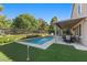 A beautiful backyard showcasing a pool, putting green, and covered patio perfect for outdoor entertaining at 364 Trentino Alto St, Henderson, NV 89012