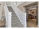 Elegant staircase with white railing leading to the second floor, adjacent to a brick-walled room at 364 Trentino Alto St, Henderson, NV 89012