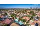 An aerial perspective reveals a community with tiled roofs, swimming pools, and the Las Vegas Strip skyline in the distance at 3877 Platis Cir, Las Vegas, NV 89103
