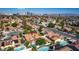 Aerial view of a residential area showcases tidy homes, landscaping, and a stunning view of the Las Vegas Strip at 3877 Platis Cir, Las Vegas, NV 89103