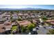 A home aerial view with a pool, roof, and neighborhood showcasing the setting and privacy at 3877 Platis Cir, Las Vegas, NV 89103