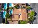 A high-angle view reveals a home with a terracotta-tiled roof, lush landscaping, and a sparkling pool at 3877 Platis Cir, Las Vegas, NV 89103