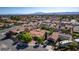 Aerial shot of a well-maintained neighborhood with lush greenery and terracotta roofs at 3877 Platis Cir, Las Vegas, NV 89103