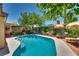 Outdoor pool and patio area perfect for entertaining, surrounded by lush landscaping and lounge chairs at 3877 Platis Cir, Las Vegas, NV 89103