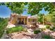 Charming outdoor space features a shaded patio, lovely fountain and lush green landscaping at 3877 Platis Cir, Las Vegas, NV 89103