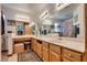 Bright bathroom with dual sinks, marble countertops, and wood cabinetry offering ample storage space at 3877 Platis Cir, Las Vegas, NV 89103