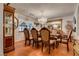 Elegant dining room with hardwood floors, large chandelier, and seating for six at 3877 Platis Cir, Las Vegas, NV 89103