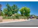 Front exterior of a house with a manicured front yard, fence, and sidewalk enhancing the curb appeal at 3877 Platis Cir, Las Vegas, NV 89103