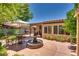 Backyard patio with fountain, shade trees and patio furniture at 3877 Platis Cir, Las Vegas, NV 89103