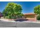 Exterior of a single-story home showcasing a well-manicured lawn, mature trees, and driveway at 3877 Platis Cir, Las Vegas, NV 89103