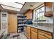 Kitchen showcasing wood cabinets, stainless steel appliances, granite countertops, and a bright skylight at 3877 Platis Cir, Las Vegas, NV 89103